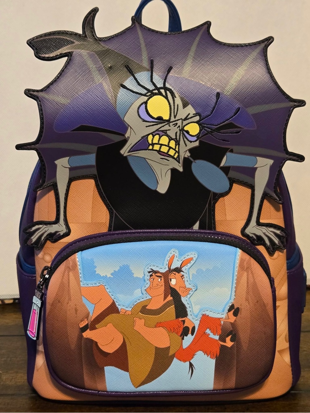 Loungefly Yzma Emperor’s New Groove Purple, Orange and Blue Graphic Backpack